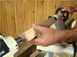 turning7 Advance the spindle against the spur center until the spurs are engaged in the relief cuts.